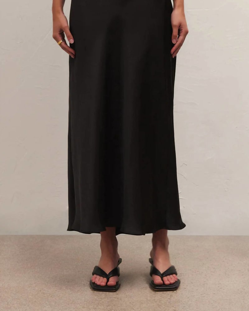 Front of a model wearing a size LARGE Europa Poly Sheen Skirt in Black in Black by Z Supply. | dia_product_style_image_id:338712